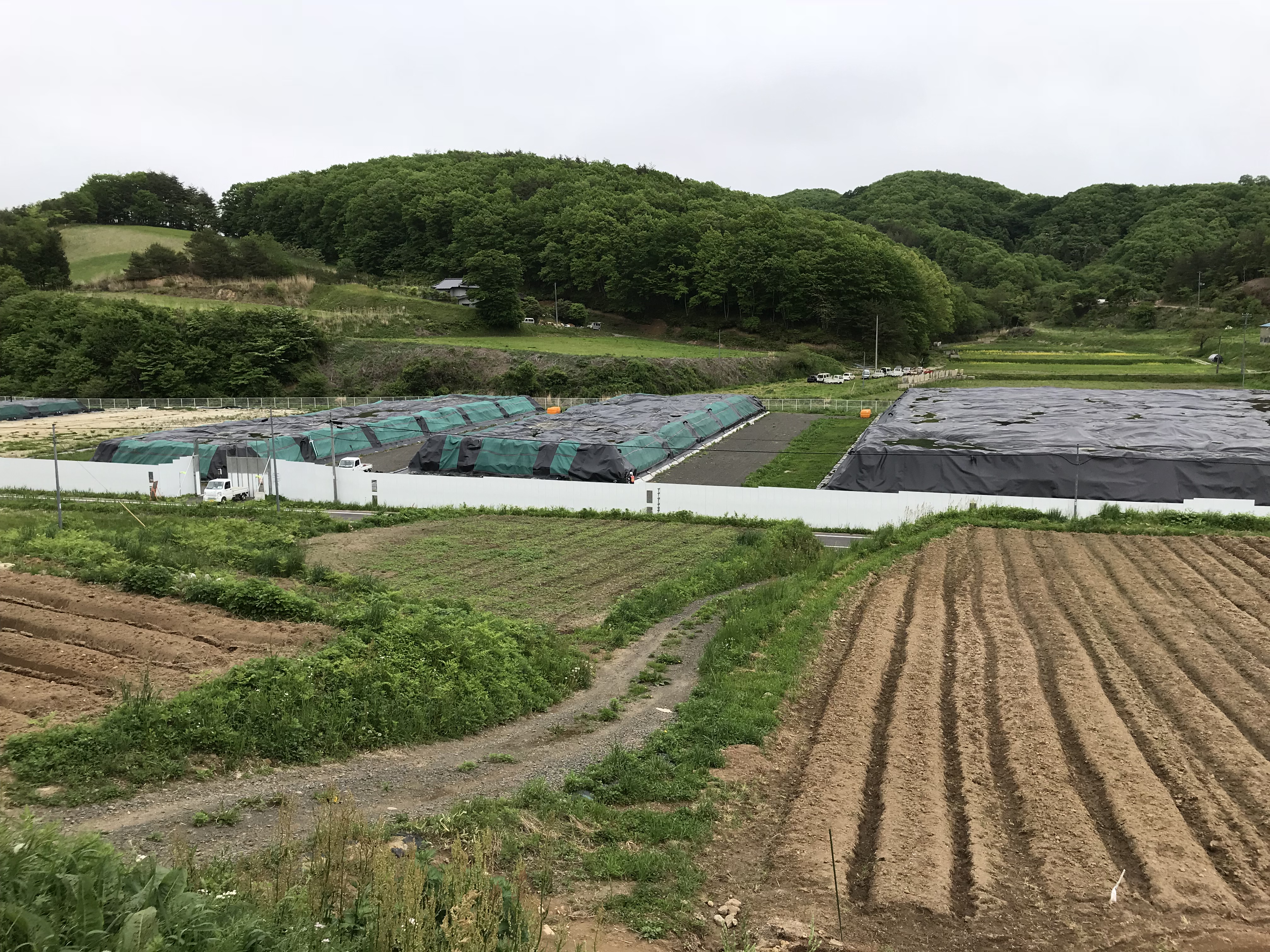 Temporarily stockpiled soil in Fukushima prefecture Japan, removed during decontamination work and awaiting transfer to an interim storage facility